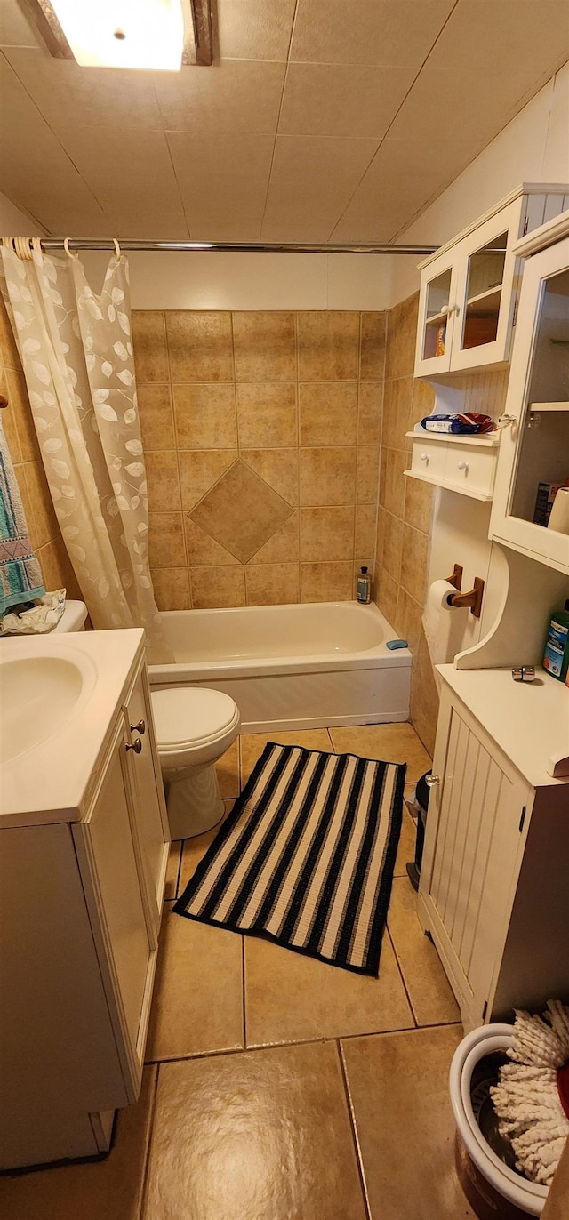 full bathroom with toilet, vanity, tile patterned flooring, and shower / tub combo with curtain