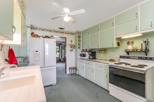 kitchen featuring white appliances, light colored carpet, ceiling fan, and sink