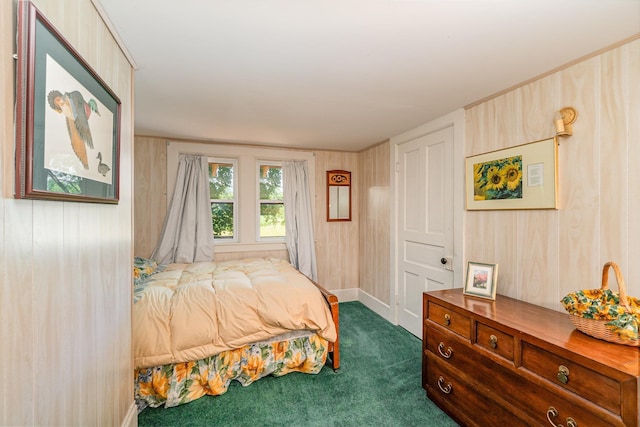 bedroom featuring wood walls and dark colored carpet