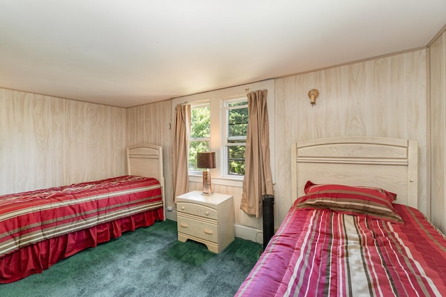 bedroom with wood walls and dark carpet