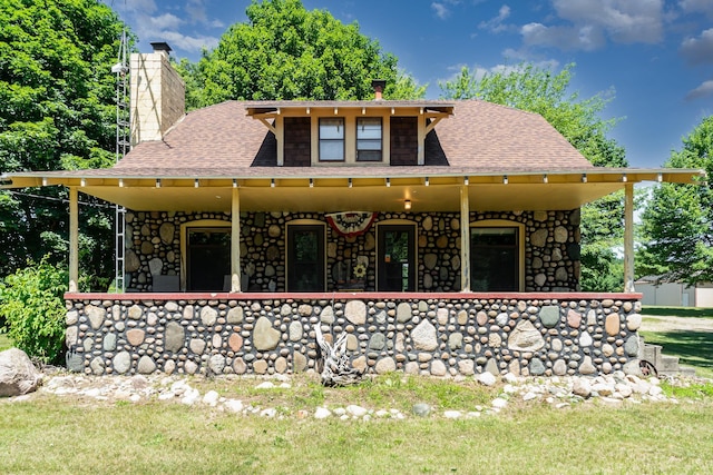 rear view of property with a porch