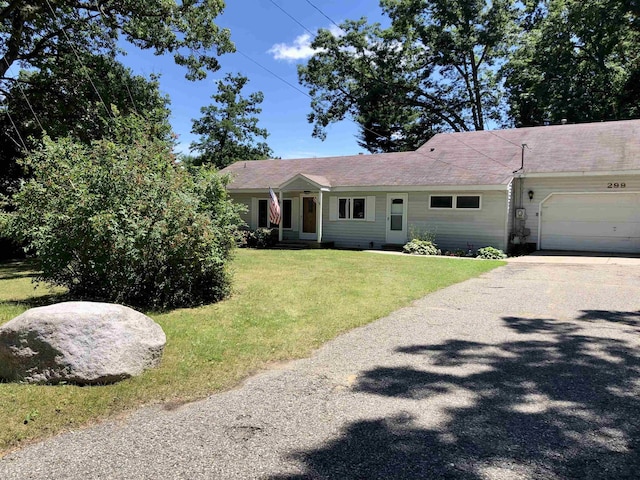 single story home featuring a garage and a front lawn