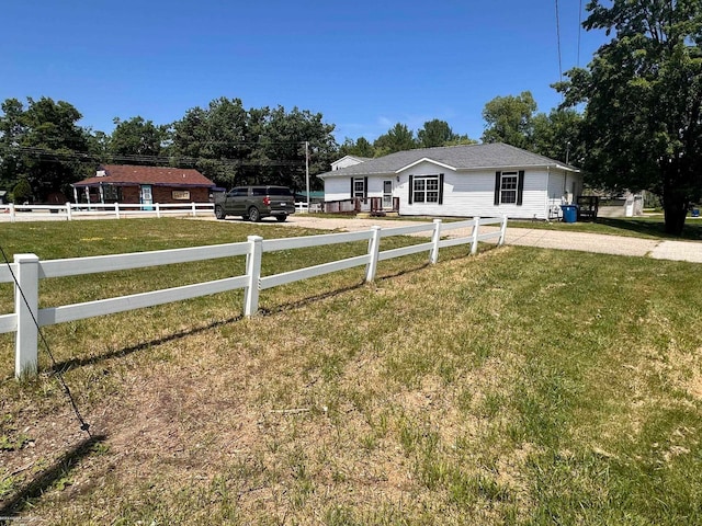 ranch-style home featuring a front yard