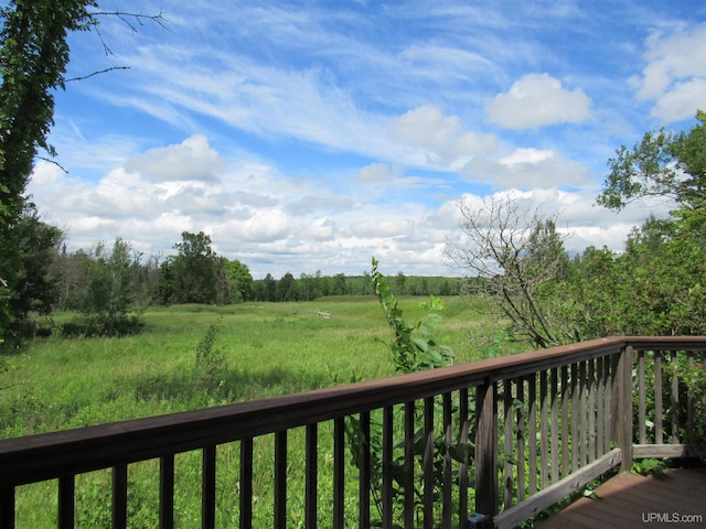 wooden terrace featuring a rural view