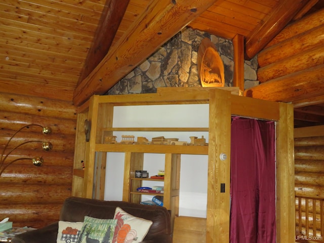 interior space with beam ceiling, rustic walls, and wood ceiling