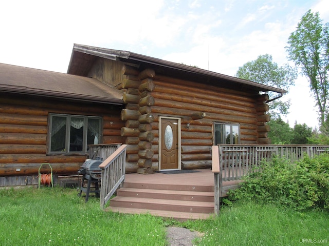 rear view of house featuring a wooden deck