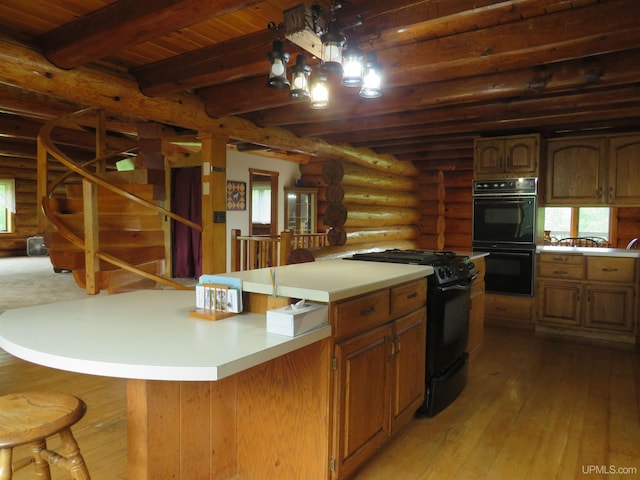 kitchen with beamed ceiling, black appliances, wood ceiling, light hardwood / wood-style floors, and rustic walls