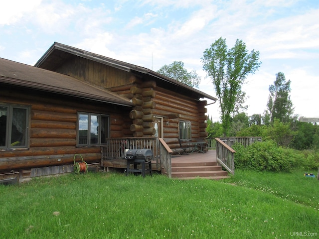 exterior space featuring a lawn and a wooden deck