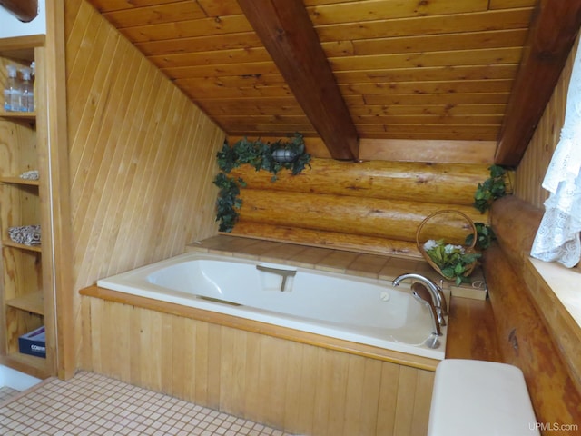 bathroom featuring tile patterned floors, a tub, wood walls, and wooden ceiling