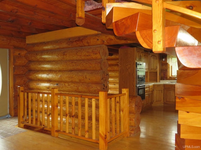 interior space featuring log walls and light wood-type flooring