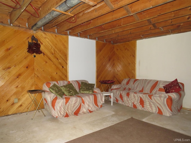 living room with concrete flooring and wooden walls