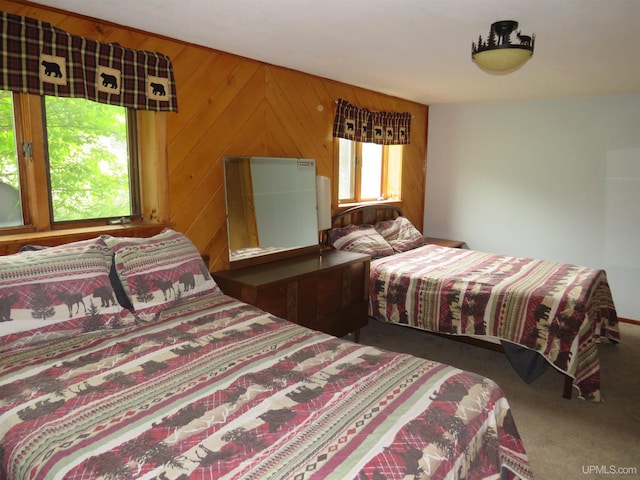 bedroom featuring carpet floors and wooden walls