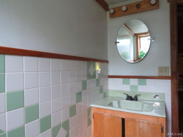 bathroom with vanity, decorative backsplash, and tile walls