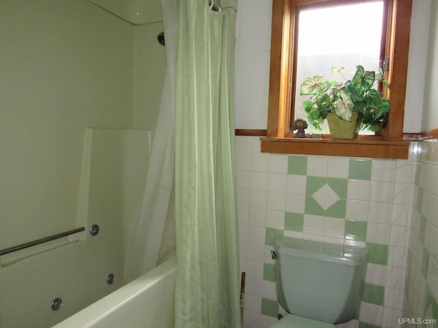 bathroom with tile walls, toilet, and shower / bath combination with curtain