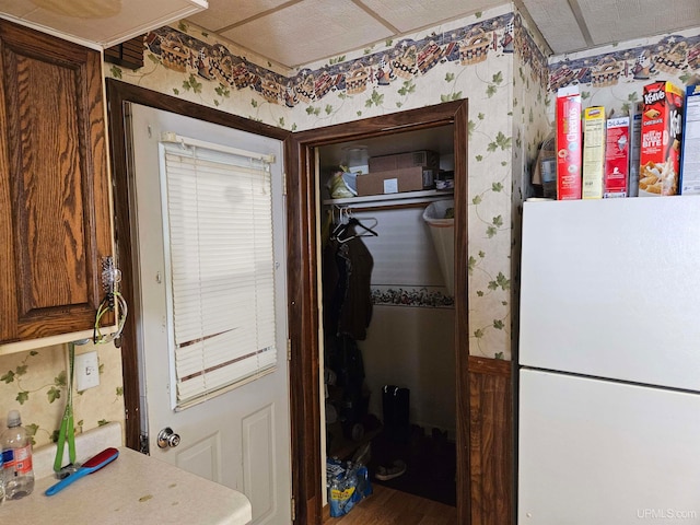 kitchen with white fridge and wood-type flooring