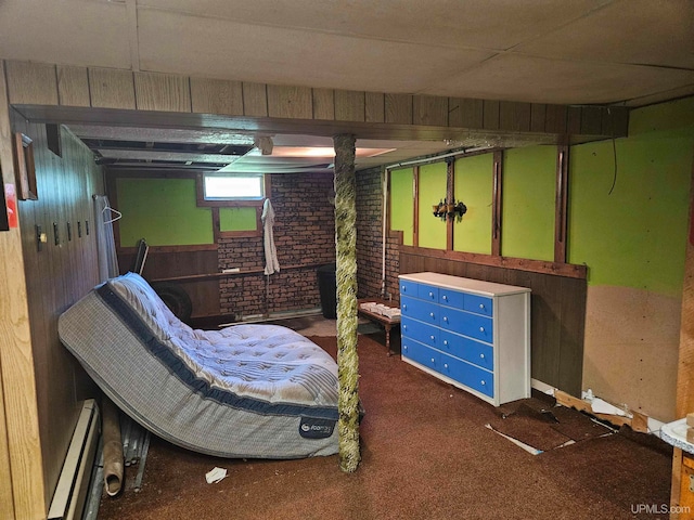 bedroom featuring carpet floors, brick wall, wood walls, and a baseboard heating unit