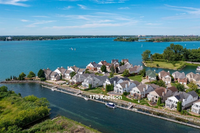 birds eye view of property featuring a water view and a residential view