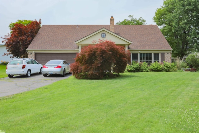 view of front of house with a garage and a front yard