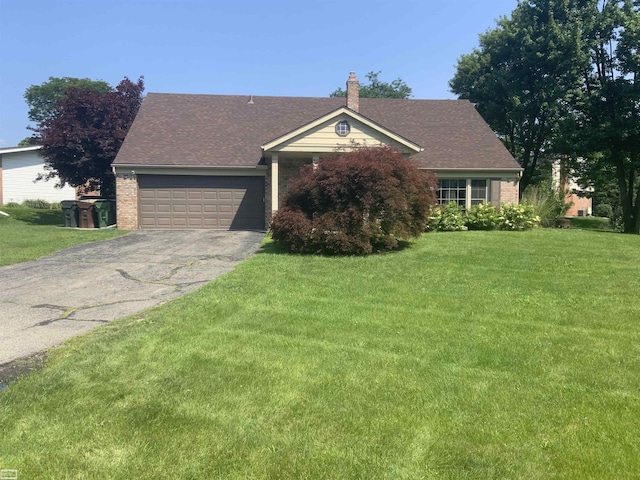 single story home with brick siding, an attached garage, a front yard, and aphalt driveway