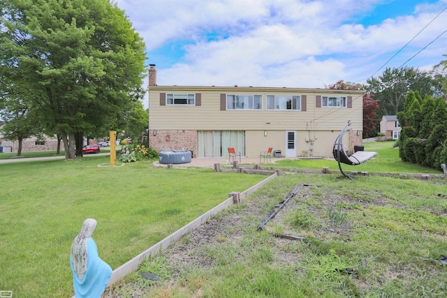 rear view of house featuring a lawn