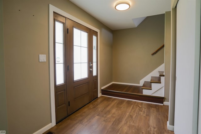 foyer entrance with wood-type flooring and a wealth of natural light