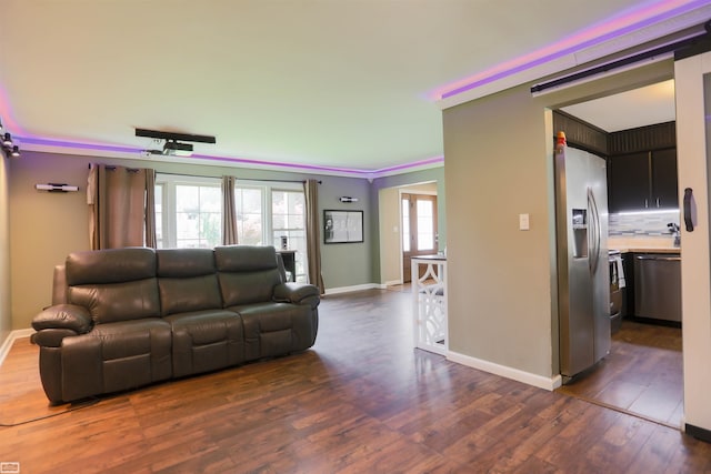 living room featuring dark wood-type flooring and ornamental molding