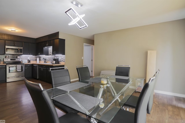 dining area with dark hardwood / wood-style flooring