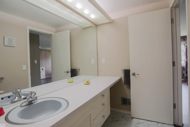 bathroom featuring baseboards, visible vents, marble finish floor, and vanity