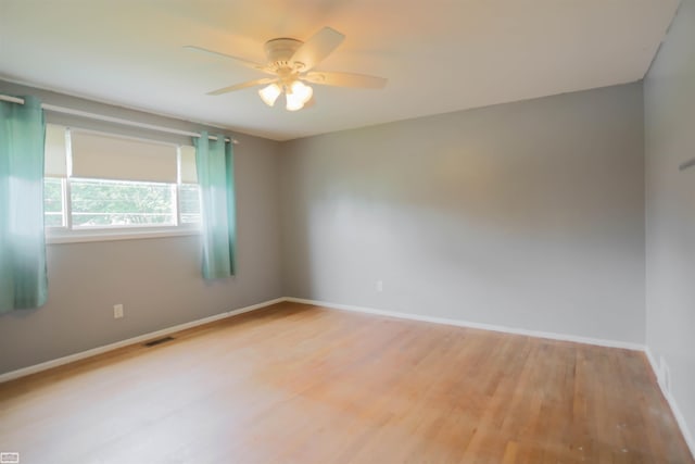 unfurnished room featuring hardwood / wood-style flooring and ceiling fan