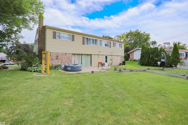 rear view of property with a patio and a yard