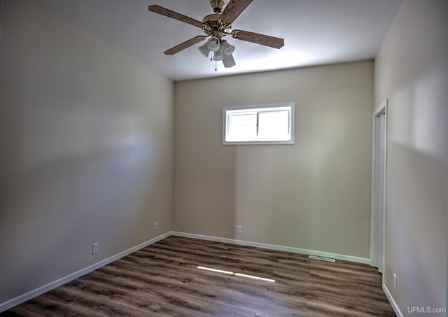 empty room with dark hardwood / wood-style floors and ceiling fan