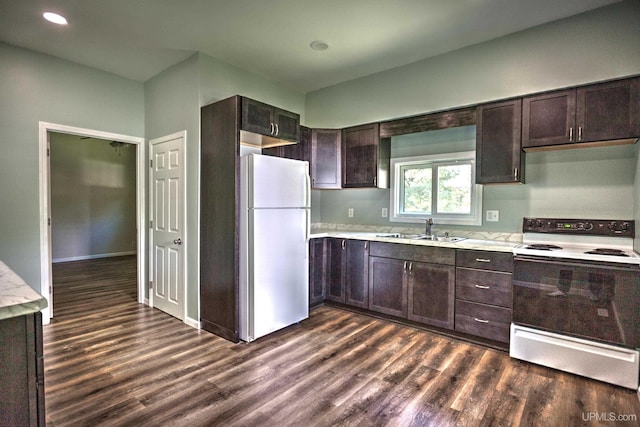 kitchen featuring dark brown cabinetry, sink, dark wood-type flooring, and white appliances