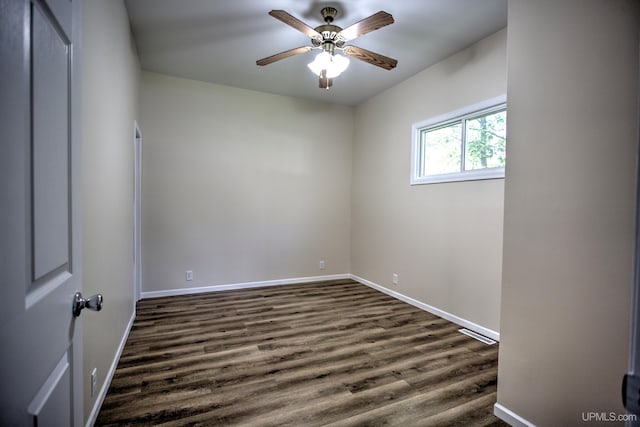 spare room with dark hardwood / wood-style floors and ceiling fan