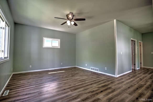 spare room featuring dark hardwood / wood-style flooring and ceiling fan