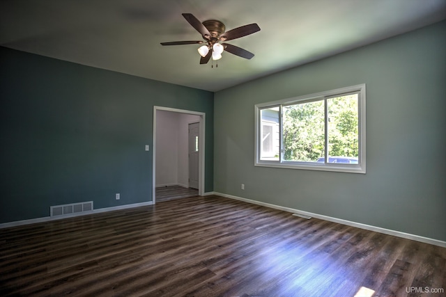 spare room with ceiling fan and dark wood-type flooring