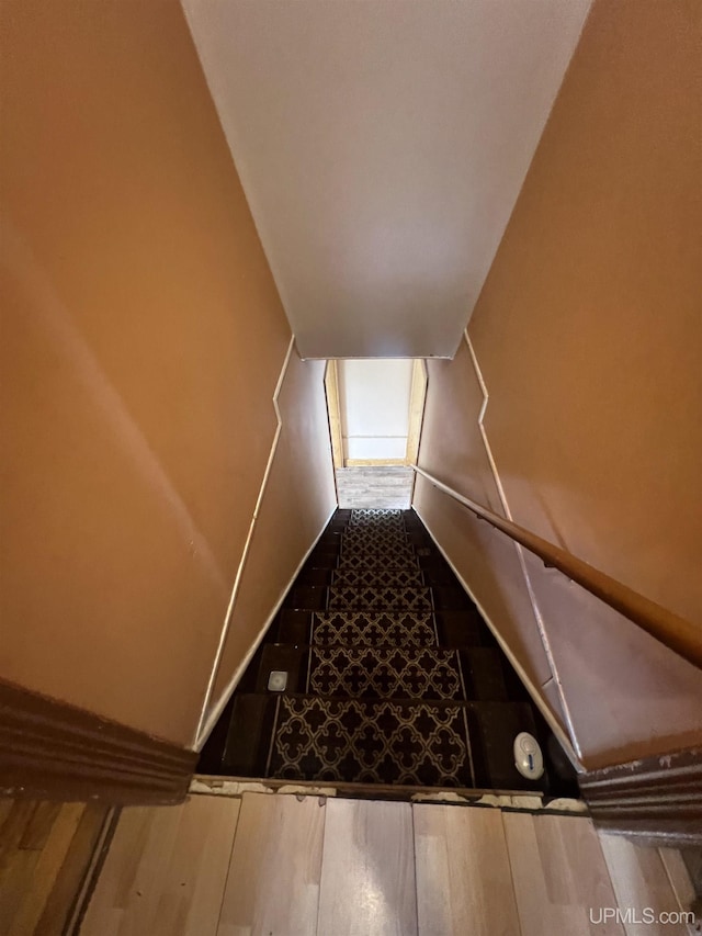 stairway with hardwood / wood-style floors