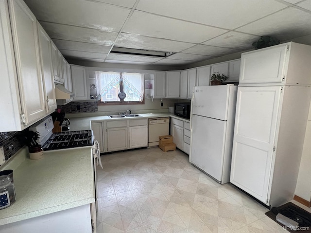 kitchen featuring a paneled ceiling, sink, white appliances, and white cabinetry