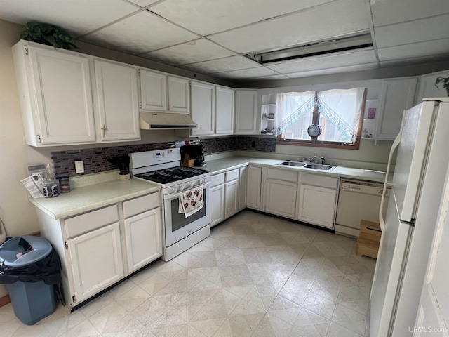 kitchen featuring white cabinetry, tasteful backsplash, white appliances, a drop ceiling, and sink