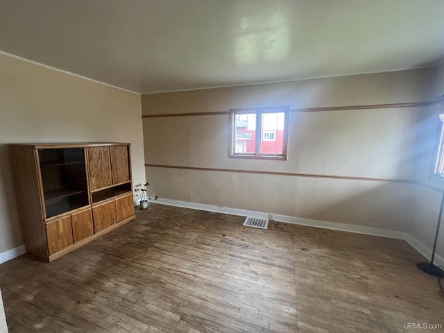 unfurnished living room with dark hardwood / wood-style flooring