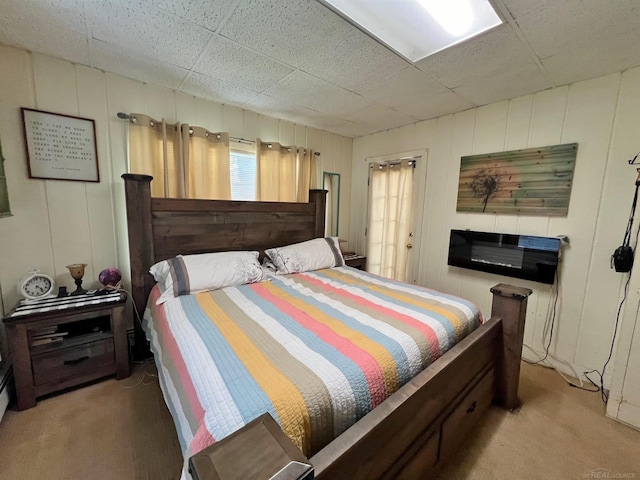 carpeted bedroom with a drop ceiling