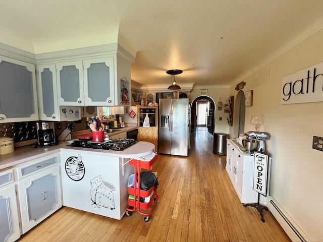 kitchen with stainless steel refrigerator with ice dispenser, gas stovetop, baseboard heating, light hardwood / wood-style floors, and white cabinetry