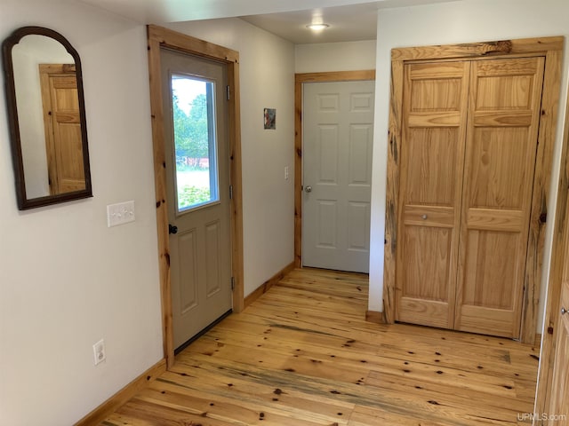 entrance foyer with light wood-style flooring and baseboards