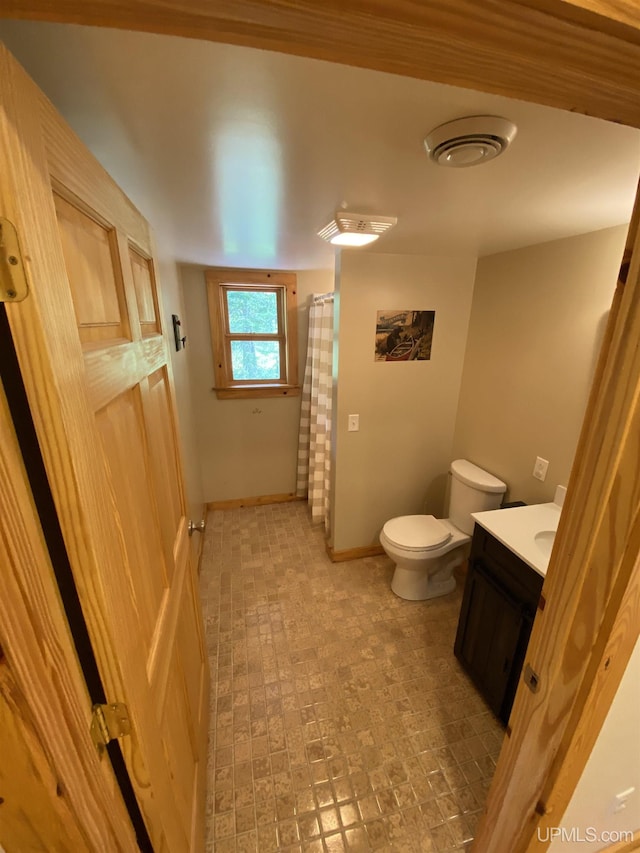 full bath featuring baseboards, vanity, toilet, and a shower with curtain