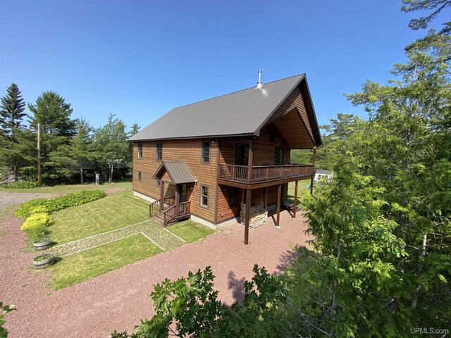 view of side of home with a yard and a wooden deck