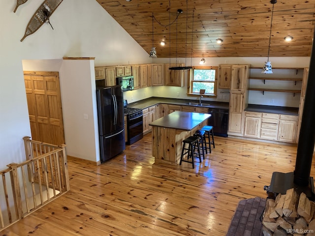 kitchen with light wood finished floors, dark countertops, high vaulted ceiling, wooden ceiling, and black appliances