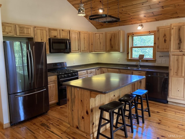 kitchen with dark countertops, black appliances, wood ceiling, and a sink