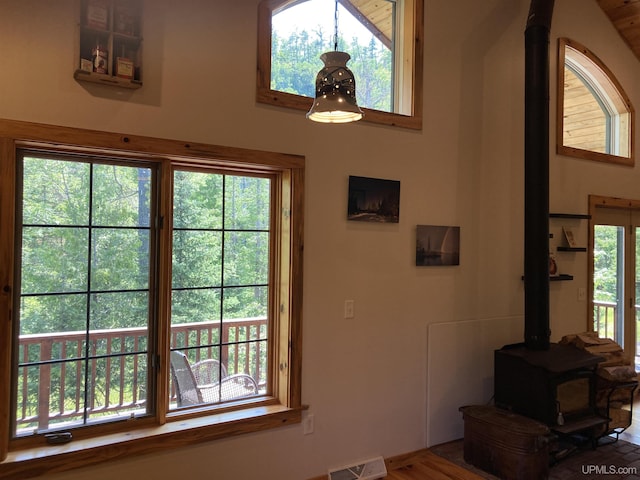 doorway to outside with a wood stove and visible vents