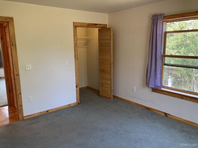 unfurnished bedroom featuring carpet floors, a closet, and baseboards