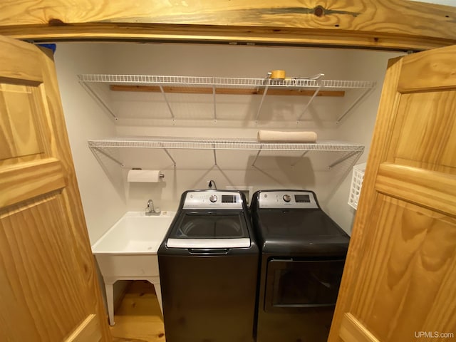 laundry area with a sink, laundry area, and washer and dryer