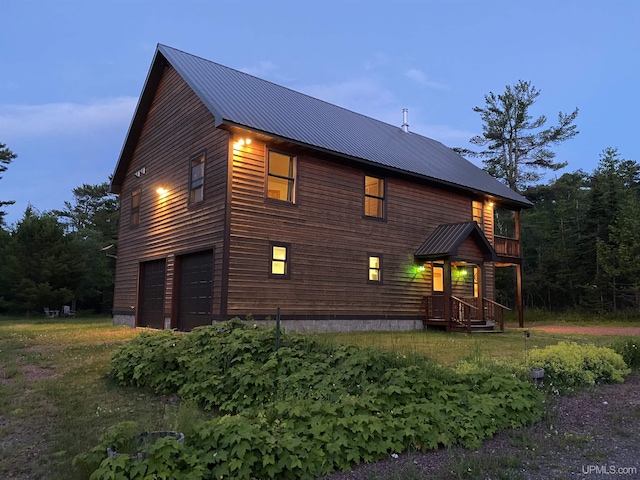 view of front of property with an attached garage and metal roof